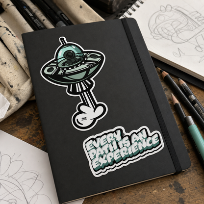 Y.B Spaceship and Every Path Is An Experience vinyl stickers on a sketchbook