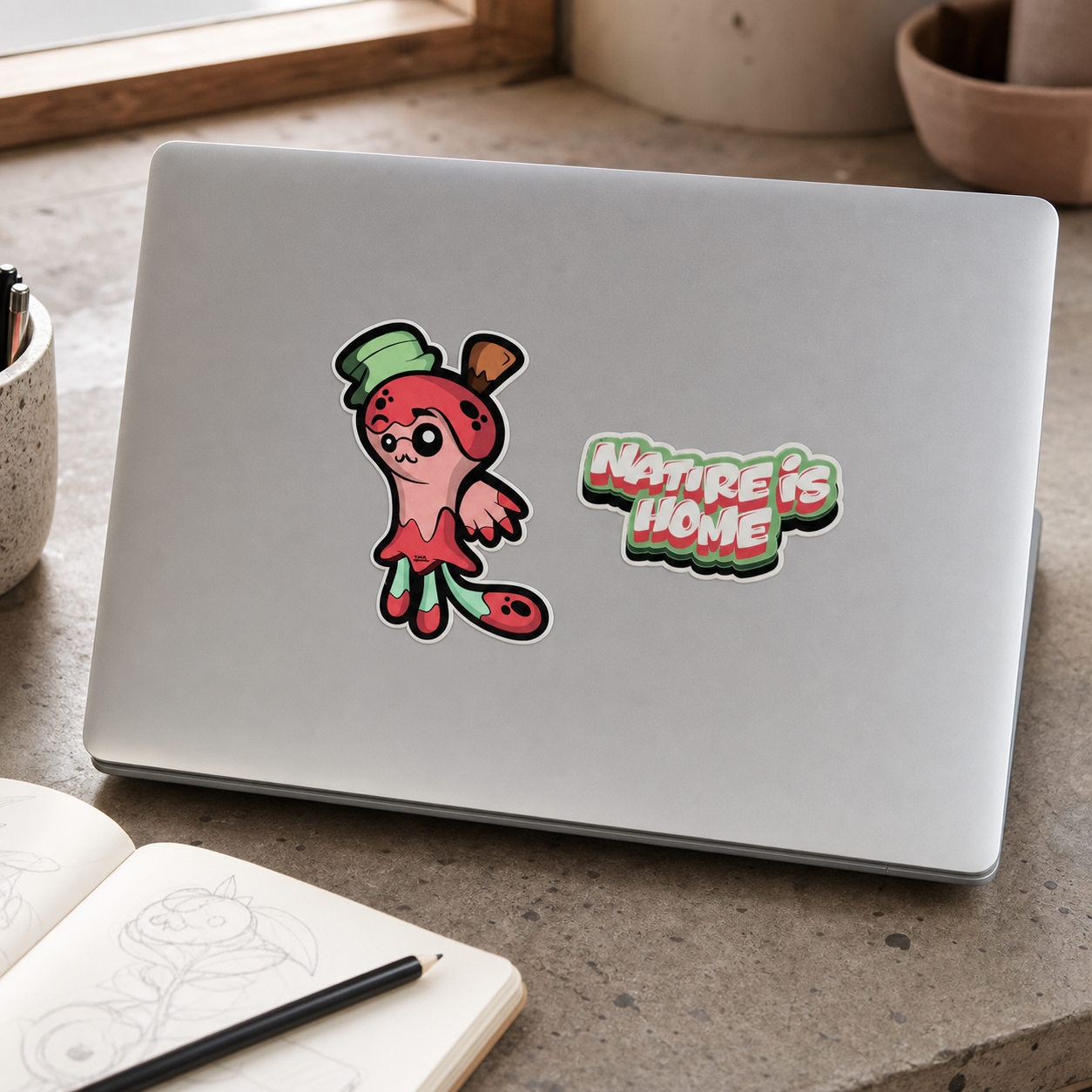 Lumi Nature Is Home vinyl stickers applied to a silver laptop